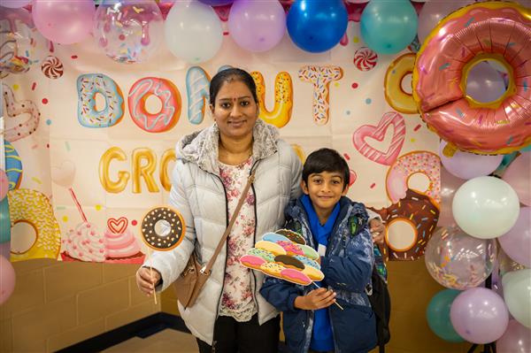 family in front of donut backdrop